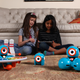 Girls, ages 8 and 9, playing with Dash & Dot.